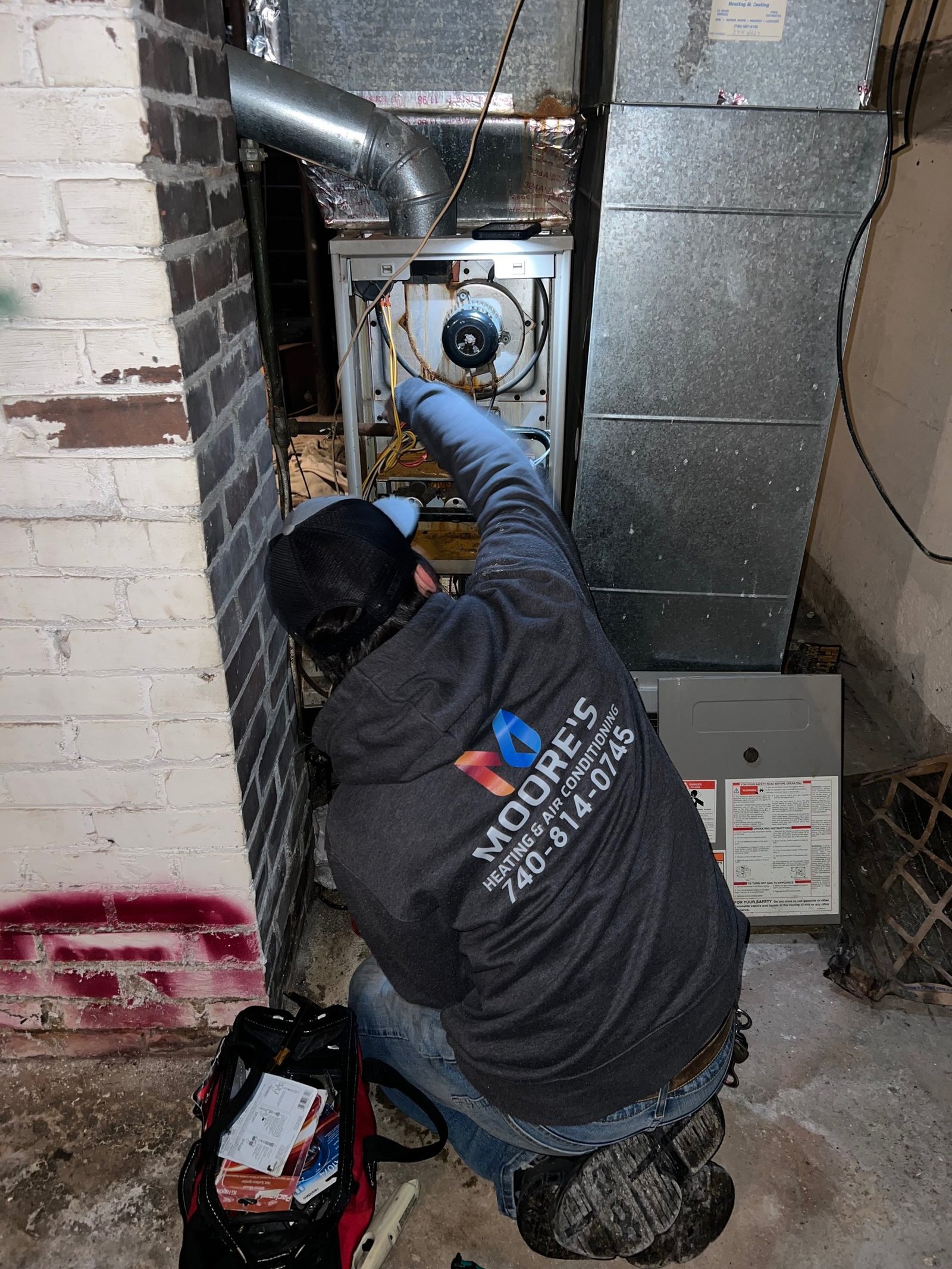 Moore's technician servicing a home HVAC system